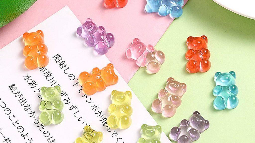 Colorful gummy vitamins in various shapes showcasing our custom gummy supplement manufacturing capabilities.