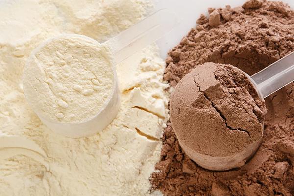 Scoop of protein powder illustrating our private label powder supplement manufacturing.