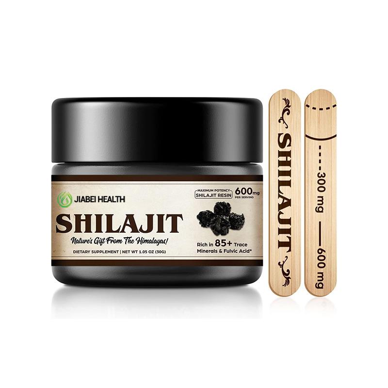 A black jar of JiaBei Health Shilajit Resin, labeled "Maximum Potency - 600mg Shilajit Resin per serving," and "Rich in 85+ Trace Minerals & Fulvic Acid." Two wooden applicators showing 300mg and 600mg measurements are beside it. This premium Himalayan Shilajit is offered by a GMP, ISO22000, HALAL, and KOSHER certified bulk provider, with a minimum order quantity of 500 units for wholesale and private label opportunities.