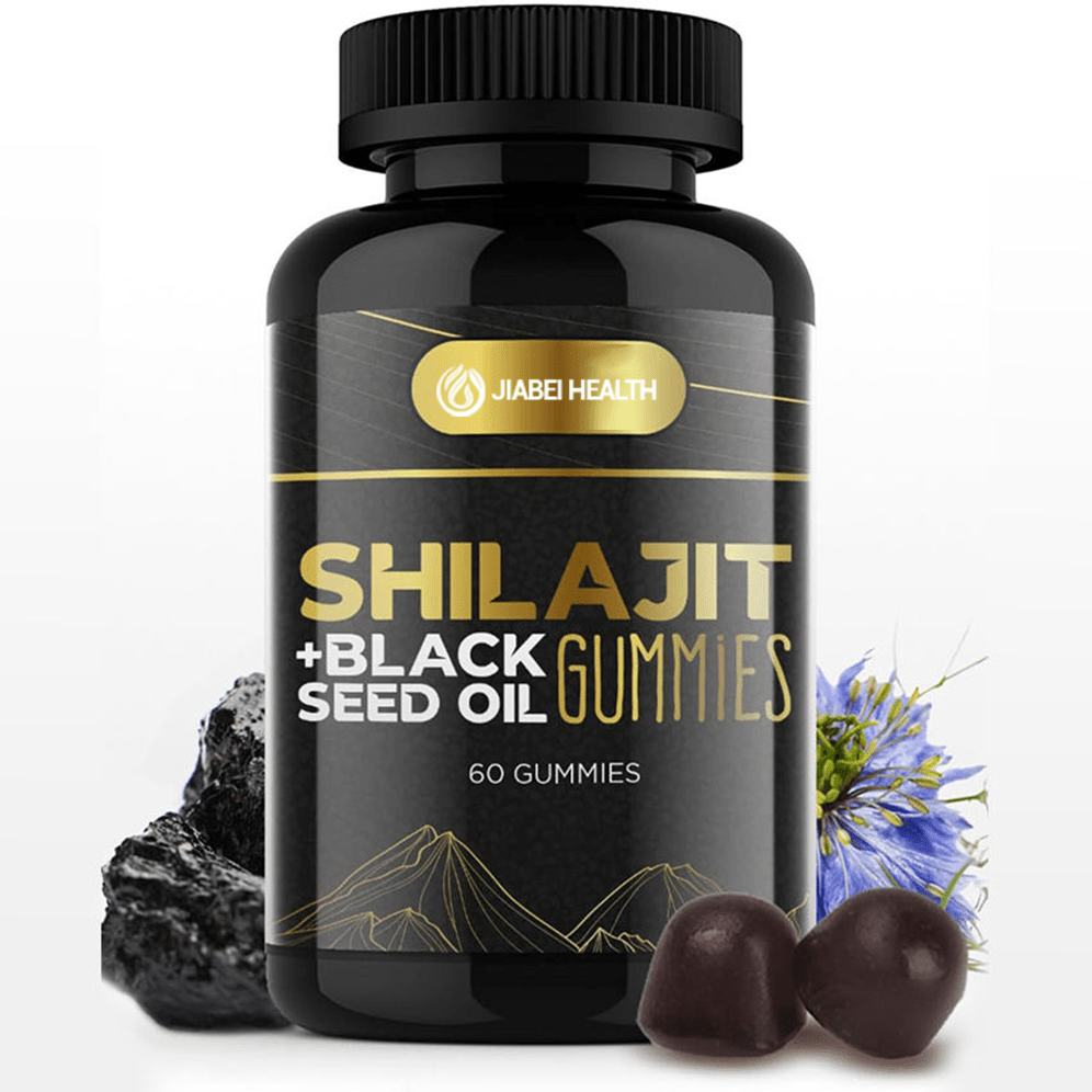 A black bottle of JiaBei Health Shilajit + Black Seed Oil Gummies with a gold label, featuring the product name prominently. Two dark-colored gummies are in the foreground, alongside raw black seed oil and a blue flower, visually representing the key ingredients. The label indicates "60 GUMMIES."