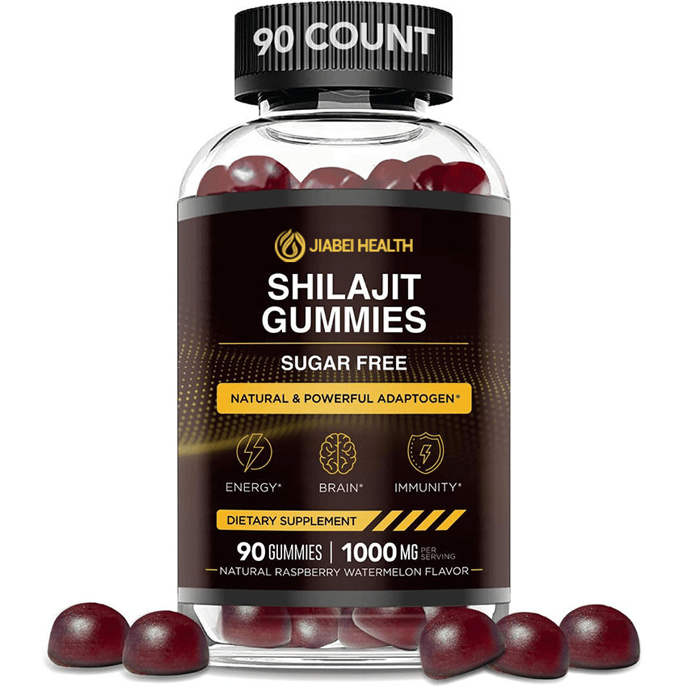 A transparent plastic bottle of JiaBei Health Shilajit Gummies, prominently labeled "SUGAR FREE" and "NATURAL & POWERFUL ADAPTOGEN." The label features icons for "ENERGY," "BRAIN," and "IMMUNITY" benefits, clearly stating "90 GUMMIES | 1000 MG PER SERVING." The gummies visible inside and scattered around the base are dark reddish-purple. The bottle has a black cap, with "90 COUNT" embossed on its top.