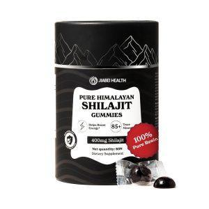 A black and white cylindrical container of JiaBei Health Pure Himalayan Shilajit Gummies, labeled "400mg Shilajit" and "Helps Boost Energy." Two dark, disc-shaped gummies are shown outside the container. This premium Pure Himalayan Shilajit Gummies product is offered by a GMP, ISO22000, HALAL, and KOSHER certified bulk provider, with a minimum order quantity of 500 units for wholesale and private label opportunities.