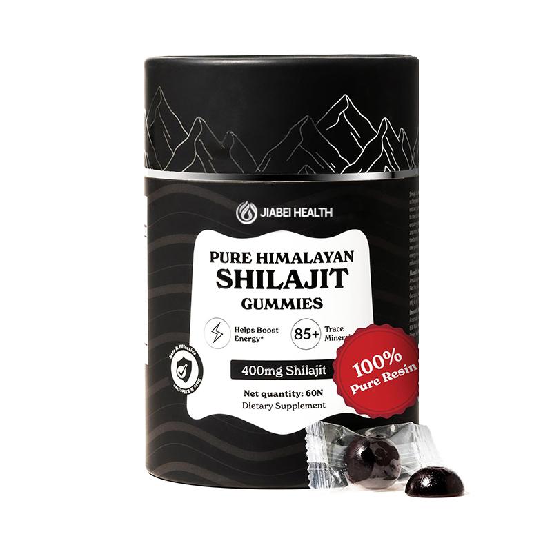 A black and white cylindrical container of JiaBei Health Pure Himalayan Shilajit Gummies, labeled "400mg Shilajit" and "Helps Boost Energy." Two dark, disc-shaped gummies are shown outside the container. This premium Pure Himalayan Shilajit Gummies product is offered by a GMP, ISO22000, HALAL, and KOSHER certified bulk provider, with a minimum order quantity of 500 units for wholesale and private label opportunities.
