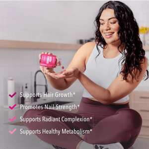 Woman taking Jiabei Health biotin gummies 5000 mcg, supporting hair growth, nail strength, radiant complexion, and healthy metabolism