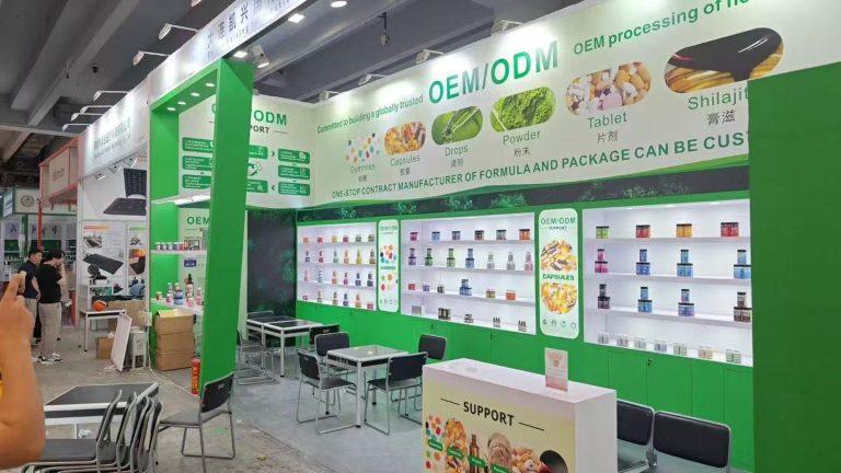 Jiabei Health OEM/ODM supplement booth at Canton Fair 2025 in Guangzhou showing gummies, capsules, powders, and tablets