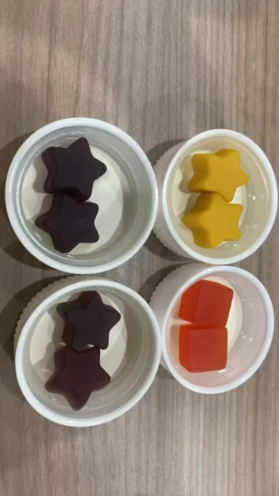 final custom gummy development sample in bottle, purple and orange gummies with glossy clean surface