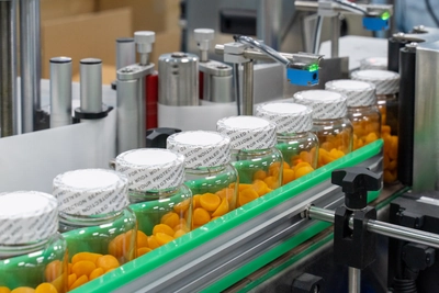 Dietary supplement gummies moving through a commercial production line