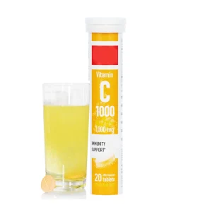 Effervescent vitamin tablets in a tube with a glass of dissolved supplement drink
